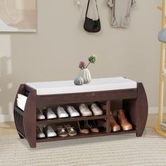 a shoe rack with shoes on it in a living room next to a coat rack