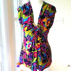 This Beautiful Colorful Printed Top Looks Like The 60's As Far As The Style Of Fabric. In The Middle The Fabric Is Brought Together With A Metal Gold Snake With Red Eyes. The Is The Slightest Cap Sleeve. The Top Measures Pit To Pit 19". Waist 16.5", And Length Of Top Is 25". Washing Instructions Are Hand Wash Gently. The Fabric Is 95% Polyester And 5% Spandex. Just A Gorgeous Blouse! It's Like Brand New! Chic V-neck Top With Bold Print, Fitted V-neck Blouse In Multicolor Print, Colorful Sleeveless Top For Summer, Multicolor V-neck Tank Top, Multicolor V-neck Tank Top For Vacation, Multicolor Summer Blouse For Party, Vibrant Print Multicolor V-neck Top, Multicolor Summer Party Blouse, Summer Multicolor Party Blouse