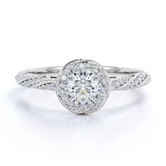 a white gold engagement ring with diamonds on the band and a round center stone in the middle