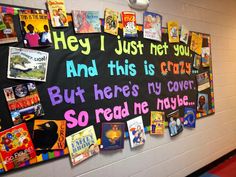 a bulletin board with many different books on it and some writing on the back wall