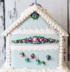 a decorated gingerbread house with beaded decorations