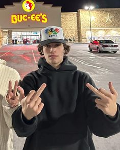 two people standing in front of a buc - ee's store