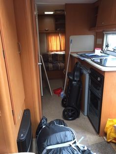 a kitchen area with an oven, sink and luggage