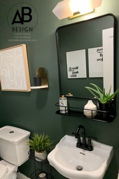 a bathroom with green walls and white fixtures