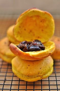 three small pastries with raisins in them on a cooling rack