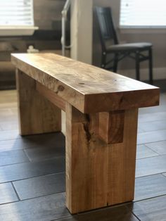 a wooden bench sitting on top of a tile floor