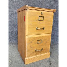 a wooden file cabinet with three drawers