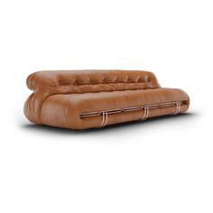 a brown leather couch sitting on top of a white floor