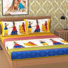 a bed with colorful bedspread and pillows on it in front of a painting