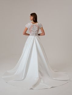 a woman in a white wedding dress looking back