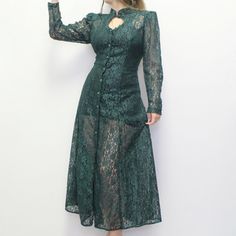 Vintage 80s Whimsigoth Lace Dress! Emerald Green Sheer Maxi dress with Victorian High collar, faceted button over a keyhole bust, long sleeves with puff shoulder pads, button up closure, A-line fit, and corset tie back! Perfect for layering for a dreamy witchy fall outfit! Size 11 by Ariana Bust: 33 3/4-36 1/2" Waist: 25 1/2-31 1/2" Hips: 40" Length: 49 1/2" emerald lace 80s dress 13.4 oz. 80s Whimsigoth, Witch Ocs, Sheer Corset Dress, Solarpunk Fashion, Corset Tie Back, Witchy Fall, Hawaiian Skirt, Dress Emerald Green, Scoop Neck Midi Dress