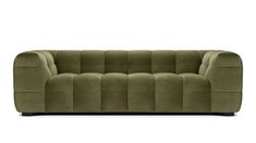 a green couch sitting on top of a white floor