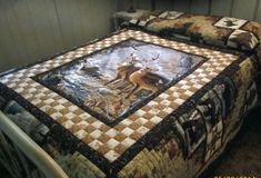 a bed with a deer quilt on it