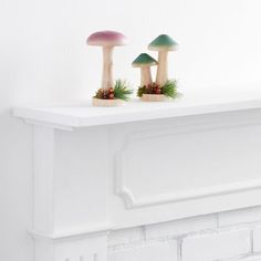 two mushrooms are sitting on top of a mantle