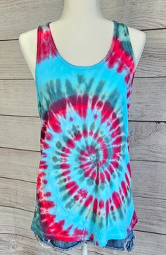 This is a tie-dye tank top.  JUNIORS FIT ( runs small for womens)  Size XL 100% cotton  See photos for size chart Casual Tie Dye Tank Top For Summer, Casual Summer Tie Dye Tank Top, Summer Cotton Tie-dye Tops, Tie Dye Sleeveless Top For Summer, Summer Cotton Tie Dye Tops, Spring Tie Dye Cotton Tank Top, Cotton Tie Dye Summer Tops, Cotton Tie-dye Summer Tops, Summer Sleeveless Tie-dye Top