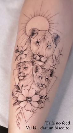 a tattoo with three lions and flowers on it