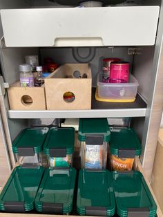 an organized pantry with plastic containers and bins on the bottom shelf for food storage