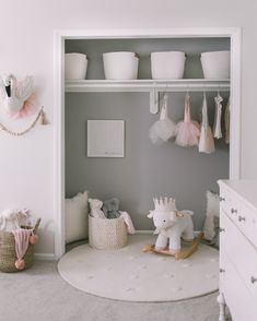 a baby's room with toys and other items in the closet, including a rocking horse