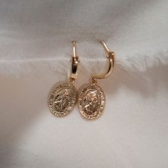 St. Christopher is a symbol of protection during travel Gold filled charm and huggie hoops Charm is 1/2" tall Gold 14k Gold-filled Huggie Earrings, 14k Gold Nickel-free Huggie Earrings, Nickel-free 14k Gold-filled Huggie Earrings, Nickel-free Gold-plated Huggie Earrings, 14k Gold Filled Tarnish Resistant Drop Huggie Earrings, 14k Gold-filled Hoop Jewelry With Dangling Charms, 14k Gold-filled Tarnish-resistant Drop Huggie Earrings, 14k Gold Huggie Earrings With Charms, Dainty 14k Gold Filled Tarnish Resistant Huggie Earrings