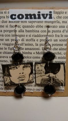 the earrings are made out of paper with black beads