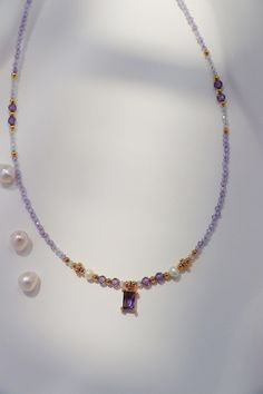 This exquisite necklace featuring a delicate string of amethyst gemstones and radiant freshwater pearls, the centerpiece is a stunning purple CZ amethyst gem framed by intricate gold detailing. Our fine craftsmanship ensures each detail is carefully placed, from the shimmering gold accents to the luminous pearls, making this piece an ideal choice for someone who appreciates refined elegance and unique designs. Treat yourself or a loved one to this beautiful piece today! Details 4*6mm amethyst CZ Lavender Amethyst Necklaces For Jewelry Making, Elegant Purple Faceted Beads Gemstones, Elegant Amethyst Gemstone Bead Necklaces, Lavender Crystal Necklaces With Faceted Beads For Gifts, Elegant Amethyst Gemstone Beads Necklace, Lavender Faceted Beads Crystal Necklace Gift, Gold Amethyst Single Strand Necklace, Lavender Amethyst Gemstone Beaded Necklace, Lavender Necklace With Faceted Beads Gift