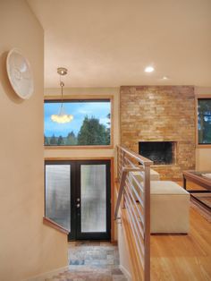 a living room filled with furniture and a fire place next to a wall mounted clock