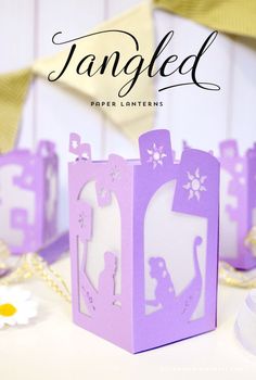 a paper princess's castle with the words tangled in white and purple on it