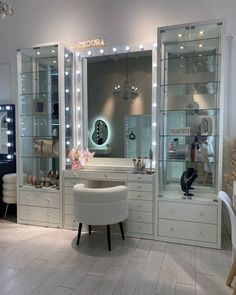 a white vanity with lighted lights in a room