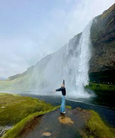 a person standing in front of a waterfall