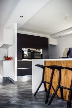 a modern kitchen with black and white accents