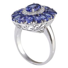 Stamped: 14K White Gold Total Ring Weight: 5.8 Grams Ring Length: N/ARing Width: N/A Gemstone Weight: Total Natural Tanzanite Weight is 4.42 Carat Quantity: 15 Color: Blue Diamond Weight: Total Natural Diamond Weight is 0.35 Carat Quantity: 14 Color: F-G, Clarity: VS2-SI1 Face Measures: 20.35x17.40 mm Sku: [703911W] Fine Jewelry Sapphire Ring With 17 Jewels, Elegant Cluster Amethyst Ring For Formal Occasions, Formal Tanzanite Ring In Fine Jewelry Style, Sapphire Cluster Ring With 17 Jewels, Formal Tanzanite Ring With 17 Jewels, Oval Sapphire Ring With 17 Jewels For Promise, Tanzanite Rings With Center Stone, Tanzanite Rings With Accent Stones In Fine Jewelry Style, Exquisite Tanzanite Ring For Anniversary