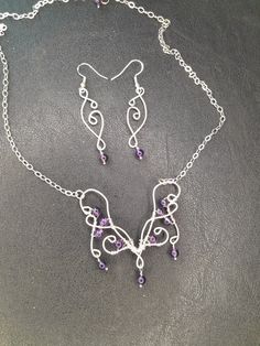 A Boho butterfly neclace in elven style for your next Renaissance fair! Made to last with .925 Sterling silver wire and Amethyst beads. The pendant is 2.25 inches wide and 2.25 inches long including the dangle on the bottom.  It's on an 18 inch chain, so the total length is about 21 inches. The dangle earrings are 2.5 inches long and 0.5 inches wide. Purple Amethyst Fantasy Jewelry, Fantasy Style Amethyst Purple Jewelry, Fantasy Style Purple Amethyst Jewelry, Fantasy Amethyst Silver Jewelry, Fantasy Style Silver Amethyst Jewelry, Fantasy Style Amethyst Silver Jewelry, Purple Wire-wrapped Silver Jewelry, Butterfly Necklace And Earrings, Elven Style