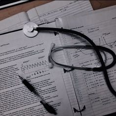 a stethoscope, pen and paper on top of some papers with writing