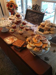 a table topped with lots of cupcakes and cakes