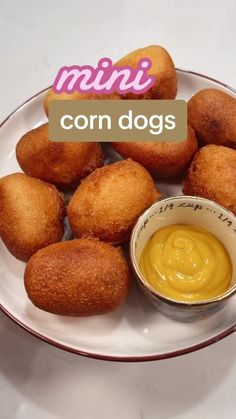 mini corn dogs on a plate with dipping sauce