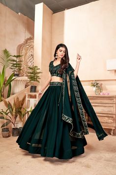 About Lehenga: This Dark Green color Lehenga choli is made of Faux Georgette fabric. It is uniquely crafted with Multi Sequins Work Add some color to your wardrobe with this gorgeous lehenga choli. This lehenga choli has a v-neck shape and comes with half sleeves. Team it with traditional accessories to elevate your looks. A matching dupatta accompanies this Lehenga Choli. The dupatta is made of Faux Georgette fabric. This lehenga choli is perfect for weddings, engagements, parties, and function Green Ghagra Lehenga Choli, Green Lahanga Design Latest, Green Choli Designs, Lahanga Design Latest Simple, Green Lengha Choli, Emerald Green Lengha, Lengha Green, Prom Lehenga