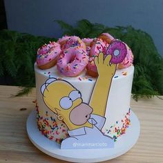 a simpsons cake with donuts and sprinkles