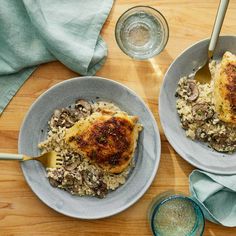 two plates filled with food on top of a wooden table