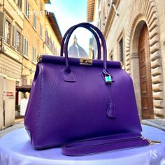 This bag has been made of the best genuine leather by local master crafters of Florence in Italy, designed for women who only accept premium Italian quality and luxury leather bags and modern Italian fashion. . Size: Height: 28 cm/11.02 inches. Width: 33 cm/12.99 inches. Depth: 15 cm/ 5.91 inches. Color: Purple . The story of this bag:  In the heart of Italy, where artistry and craftsmanship have flourished for centuries, a group of skilled artisans pours their passion into creating exquisite le Luxury Everyday Purple Bags, Luxury Purple Bags For Everyday Use, Luxury Purple Satchel, Luxury Purple Shoulder Bag For Office, Purple Leather Satchel, Purple Soft Leather Bag, High-end Bag For Everyday Use, High-end Everyday Bag With Smooth Grain, Luxury Purple Satchel For Daily Use