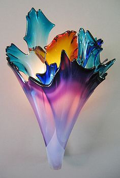 two vases with different colored glass flowers in them