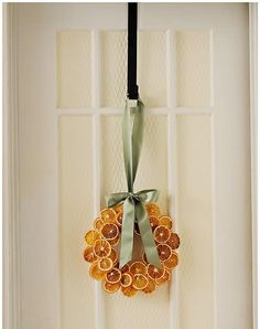 an orange wreath hangs on the front door