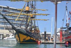 an old pirate ship is docked in the water