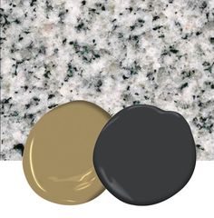 two different colors of paint sitting next to each other on a white surface with black and gold accents