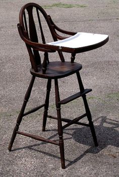 a wooden chair sitting on top of a parking lot