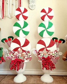 two white vases filled with candy cane decorations