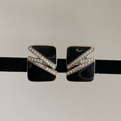 Trifari black enamel earrings designed with rhinestones in a modern timeless style.   In great vintage preowned condition from the 1970s - 1980s,  signed Trifari © Please visit for more vintage jewelry: https://vintagetimejewelry.etsy.com/ Black Enamel Clip-on Earrings For Evening, Black Rectangular Earrings For Formal Occasions, Formal Black Rectangular Earrings, Elegant Enamel Clip-on Earrings For Evening, Vintage Trifari, Gold Clips, Black Rhinestone, Enamel Earrings, Gold Enamel