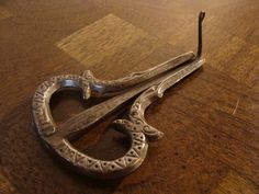 an old pair of scissors sitting on top of a wooden table