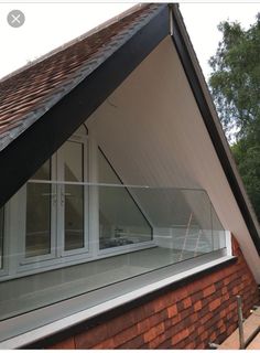 a house with a pitched roof and white windows