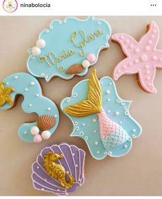 decorated cookies with mermaids and seashells on them