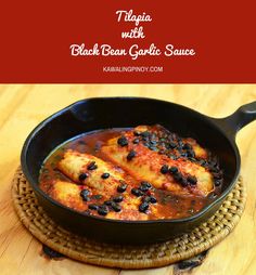 chicken with black bean garlic sauce in a cast iron skillet on a wooden table